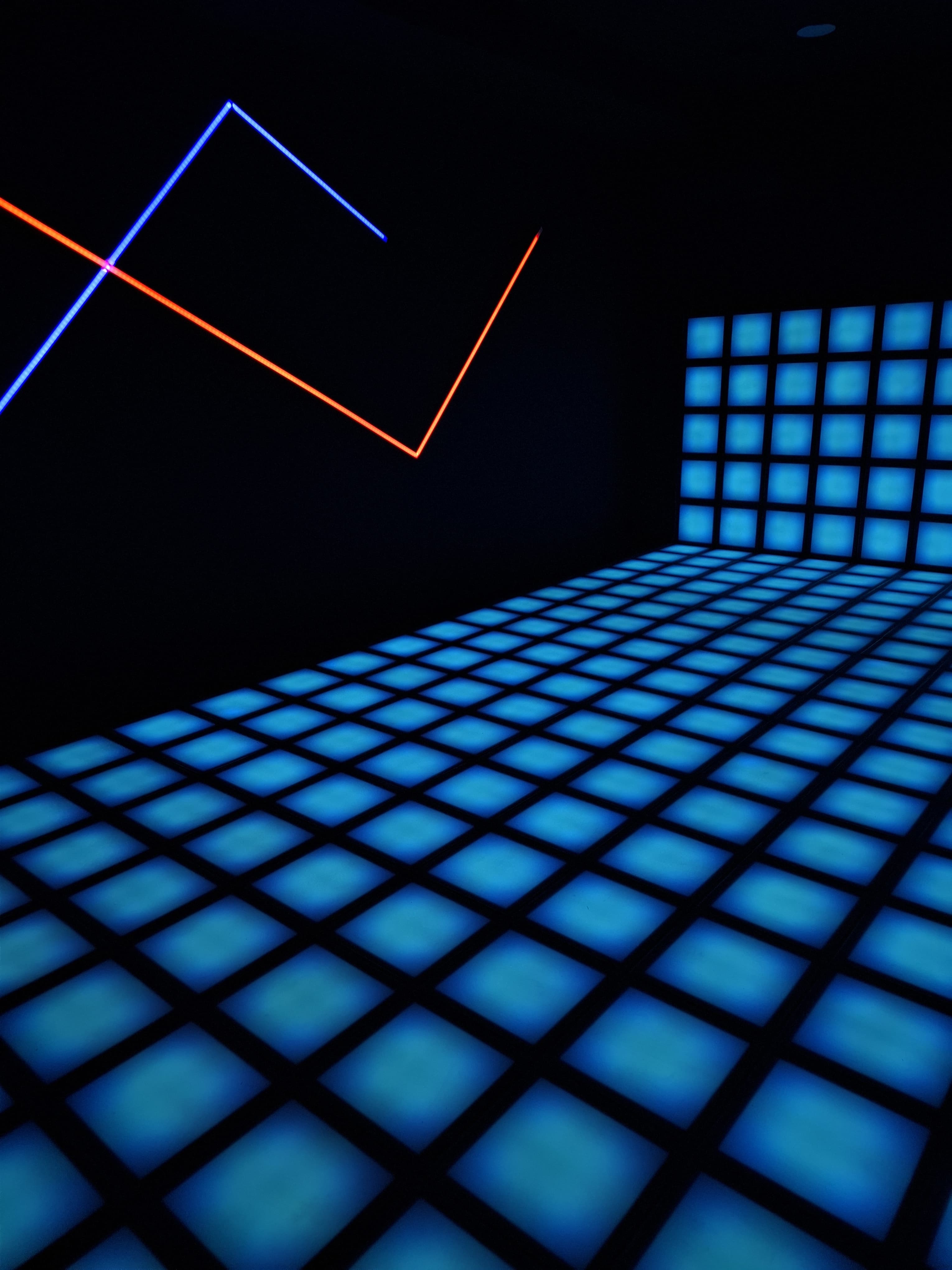 A person jumping on an interactive light-up floor game.