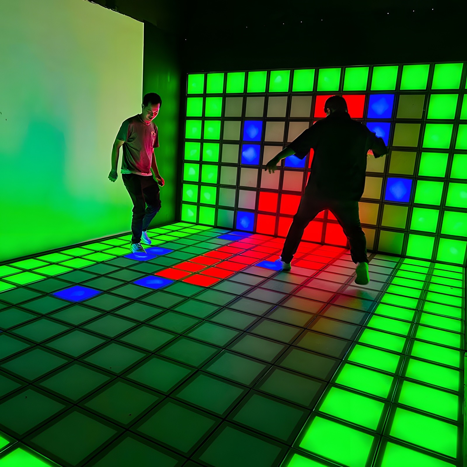 A person jumping on an interactive light-up floor game.